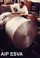 Joseph Weber [Picture, Photo, Photograph]; middle age; three-quarter view; viewing equipment; laboratory; Joseph Weber checking the wires that connect the crystals on the 38 bar, in the gravity building, around 1969.; Weber Joseph F1